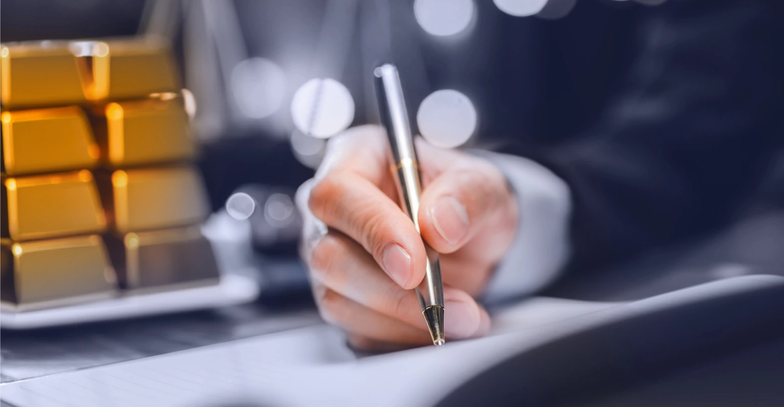 A person signing contract about gold