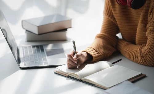 A person writing in a book