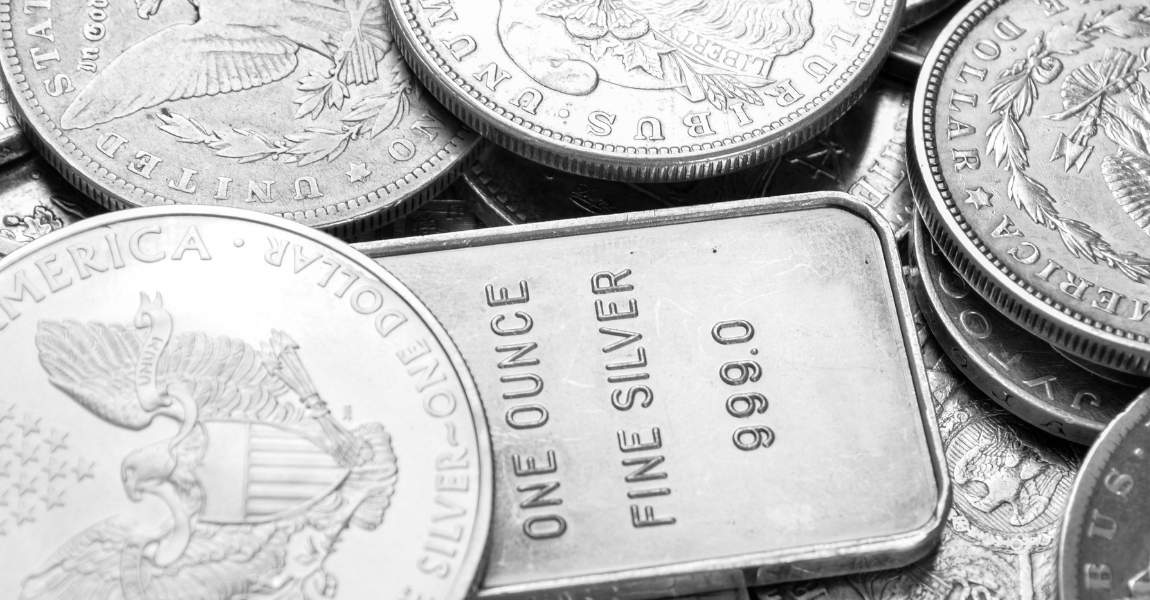 bunch of silver bars and coins