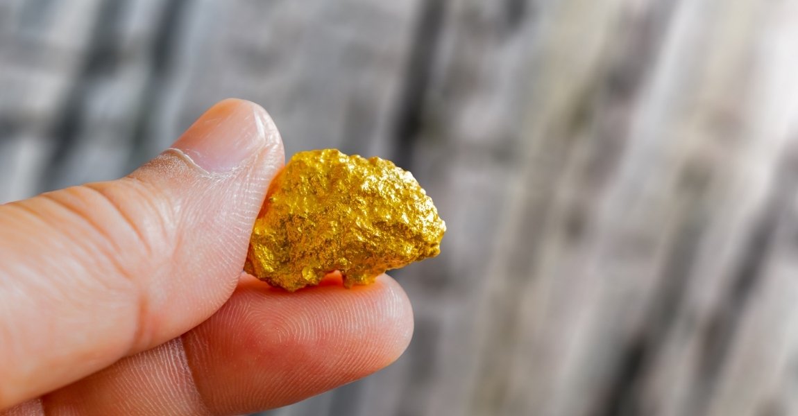 holding a gold nugget