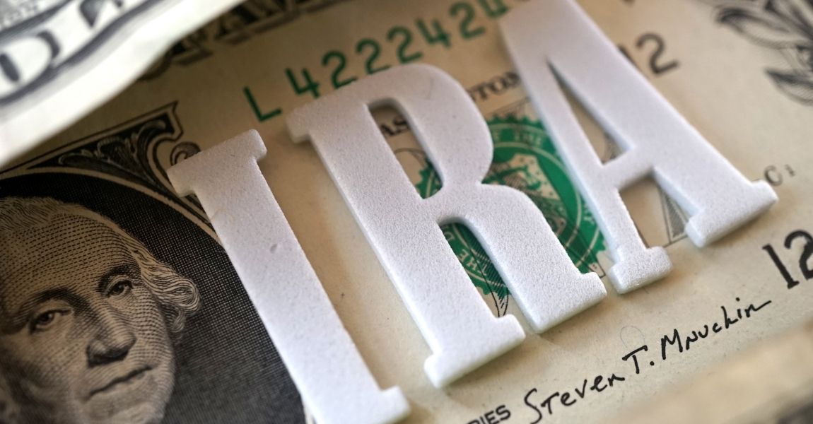 ira letters written on top of a dollar bill