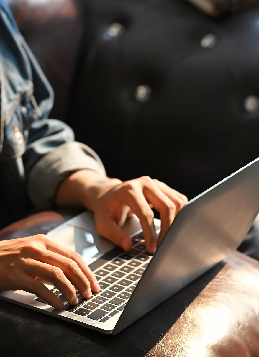 A person typing in laptop