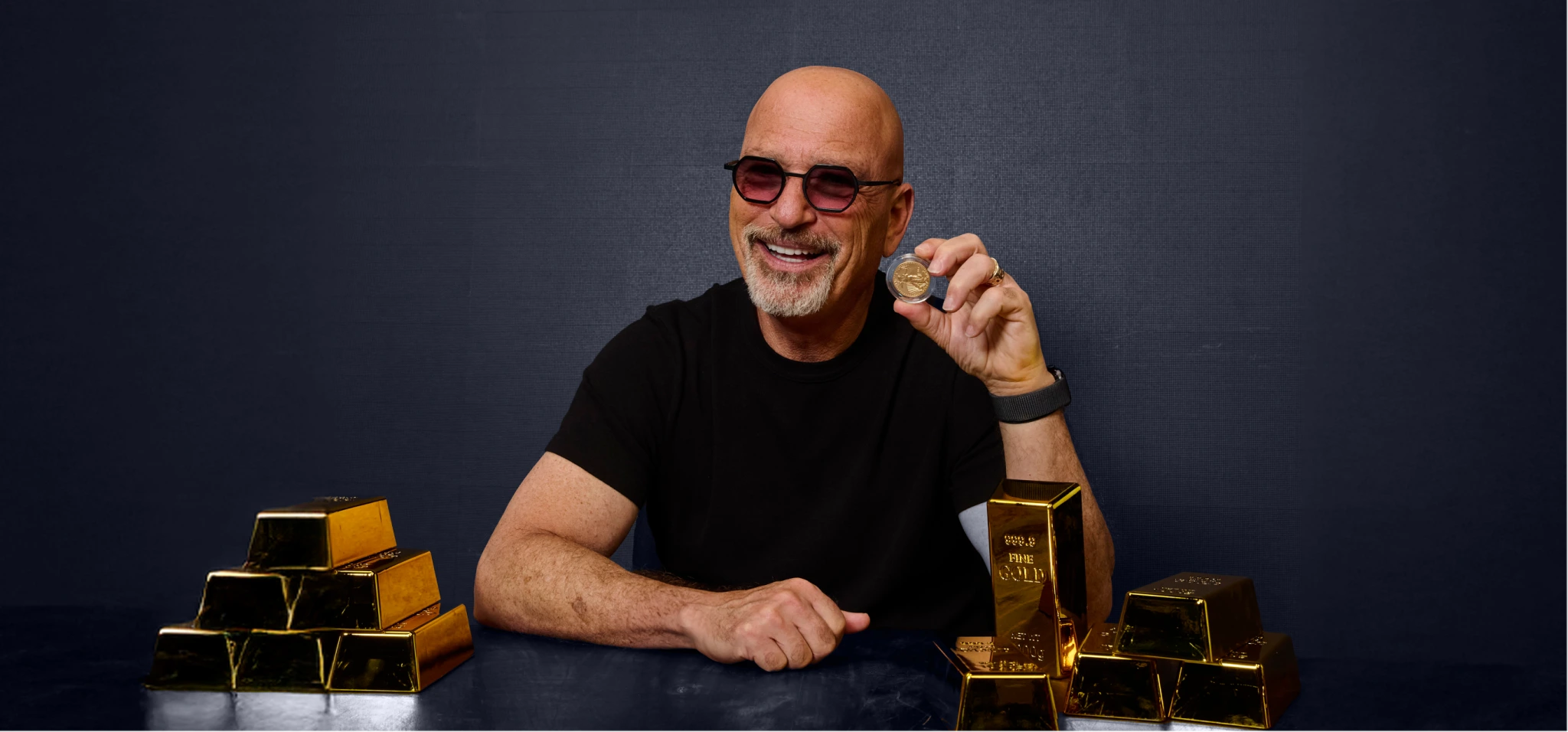 Howie Mandel flexing golds and coins