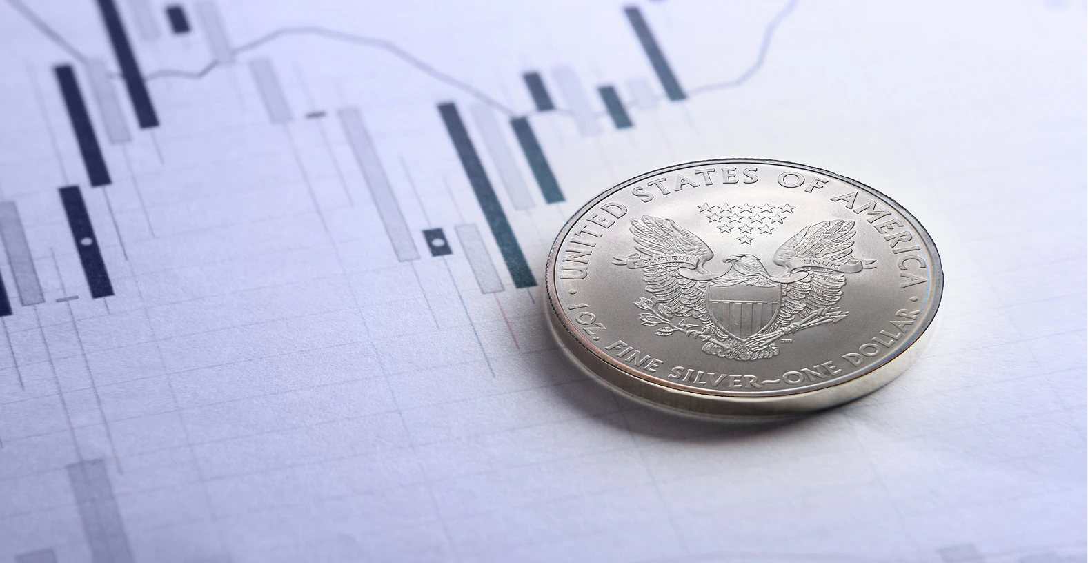 American silver coin above the analytics paper