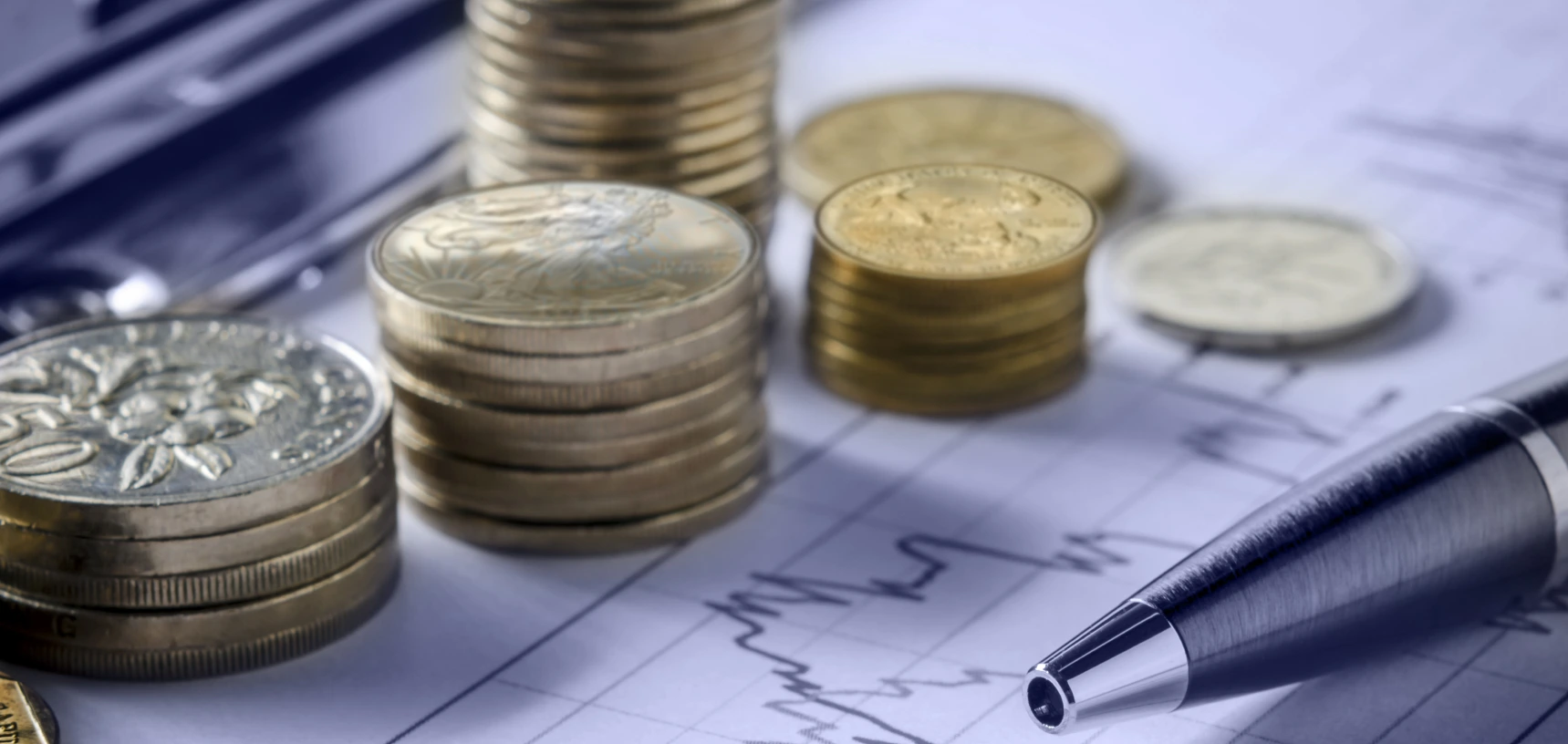 Gold coins with a pen