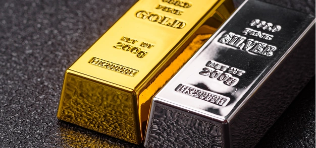 Gold and silver bullion bars placed side by side