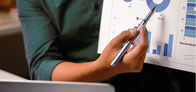 Person pointing at charts on a financial report